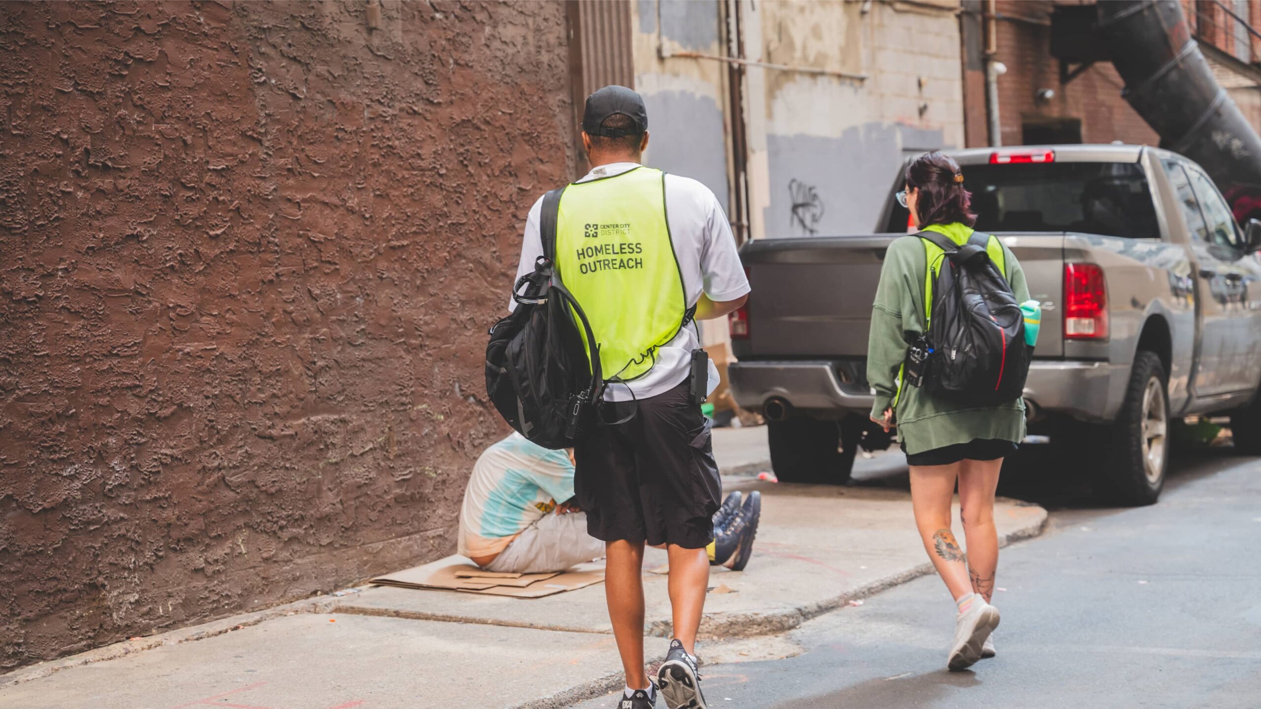 CCD outreach workers wearing a bright vest with Homeless Outreach written on the back.