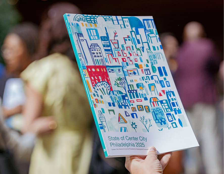 A person holds a colorful report titled 