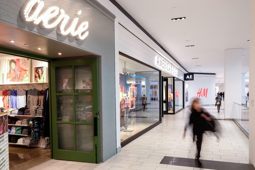blurred person walking by aerie and american eagle inside the fashion district philadelphia