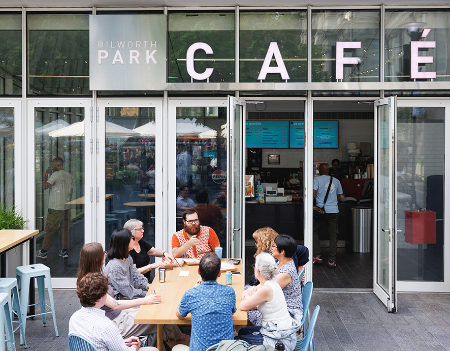 A group of people talking outside the Dilworth Park Cafe.