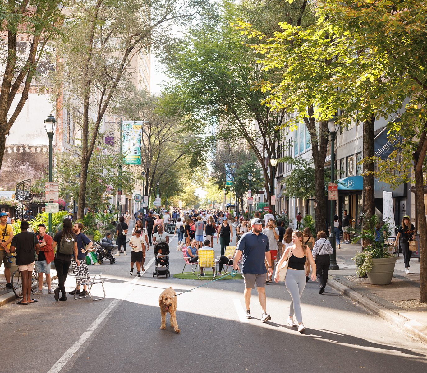 Open Streets West Walnut people enjoying the event and a couple walks their dog.