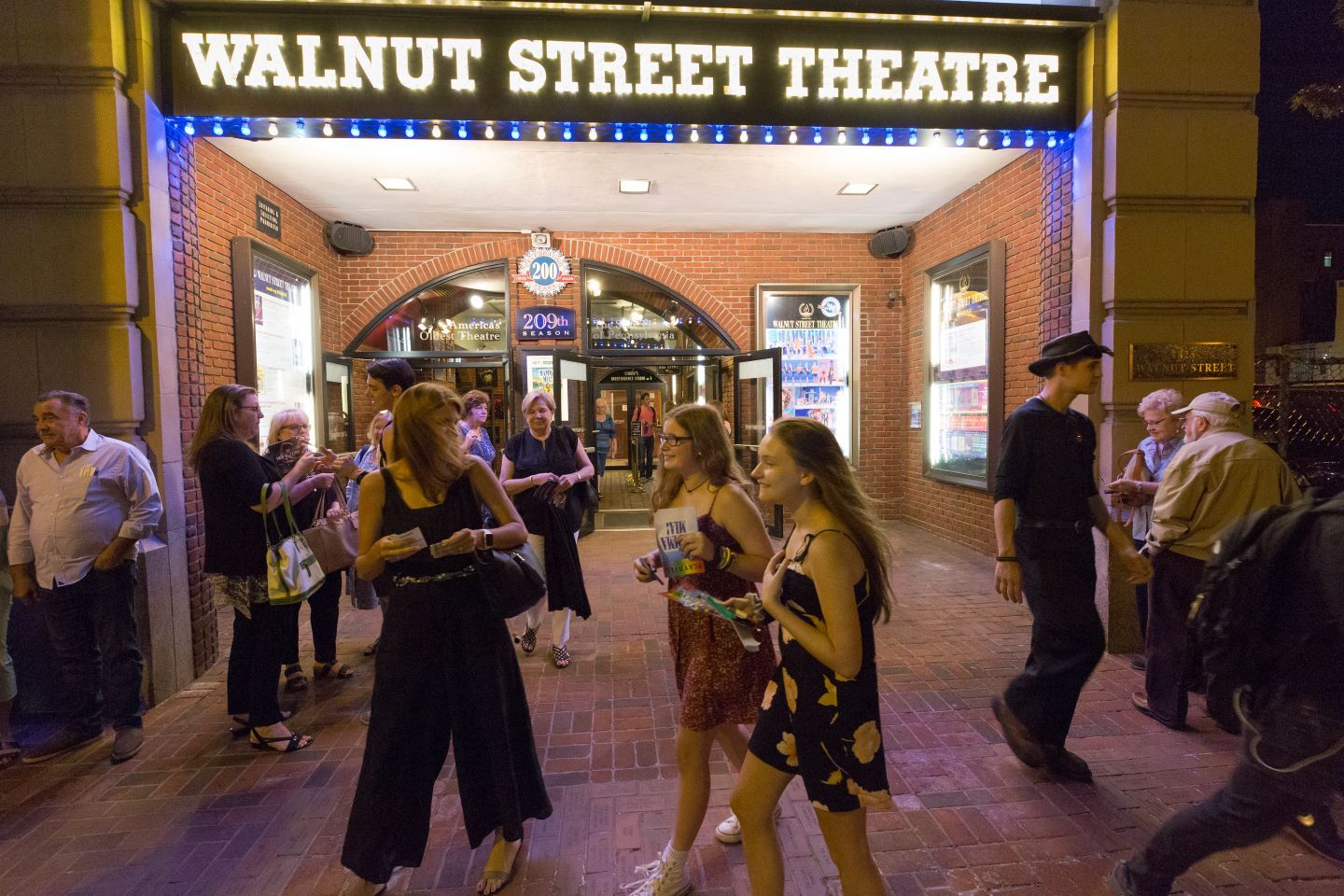 People gathered in front of the Walnut Street Theatre