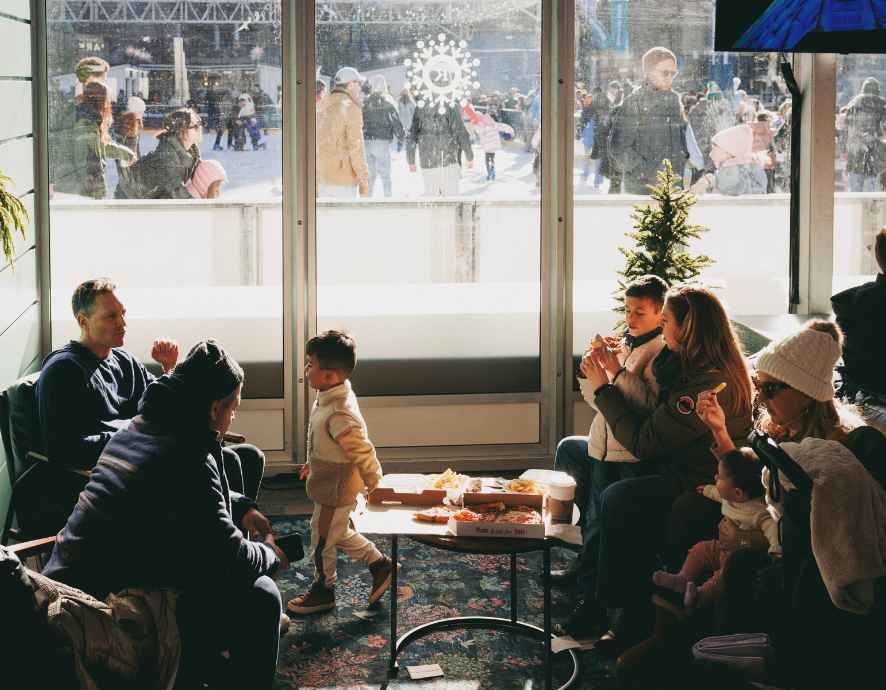 A family sitting down and enjoying a meal in the Rothman Orthopaedics Cabin.