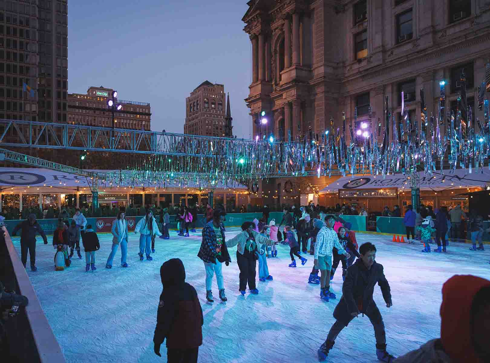 Winter at Dilworth Park people skating at the Rothman Orthopaedic Ice Rink.