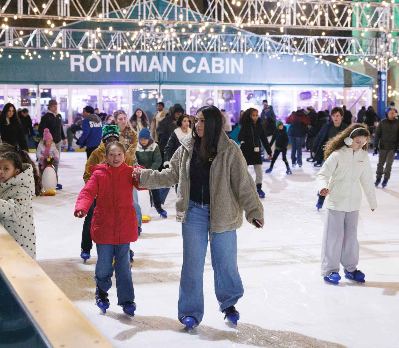 mother and daughter ice skating.