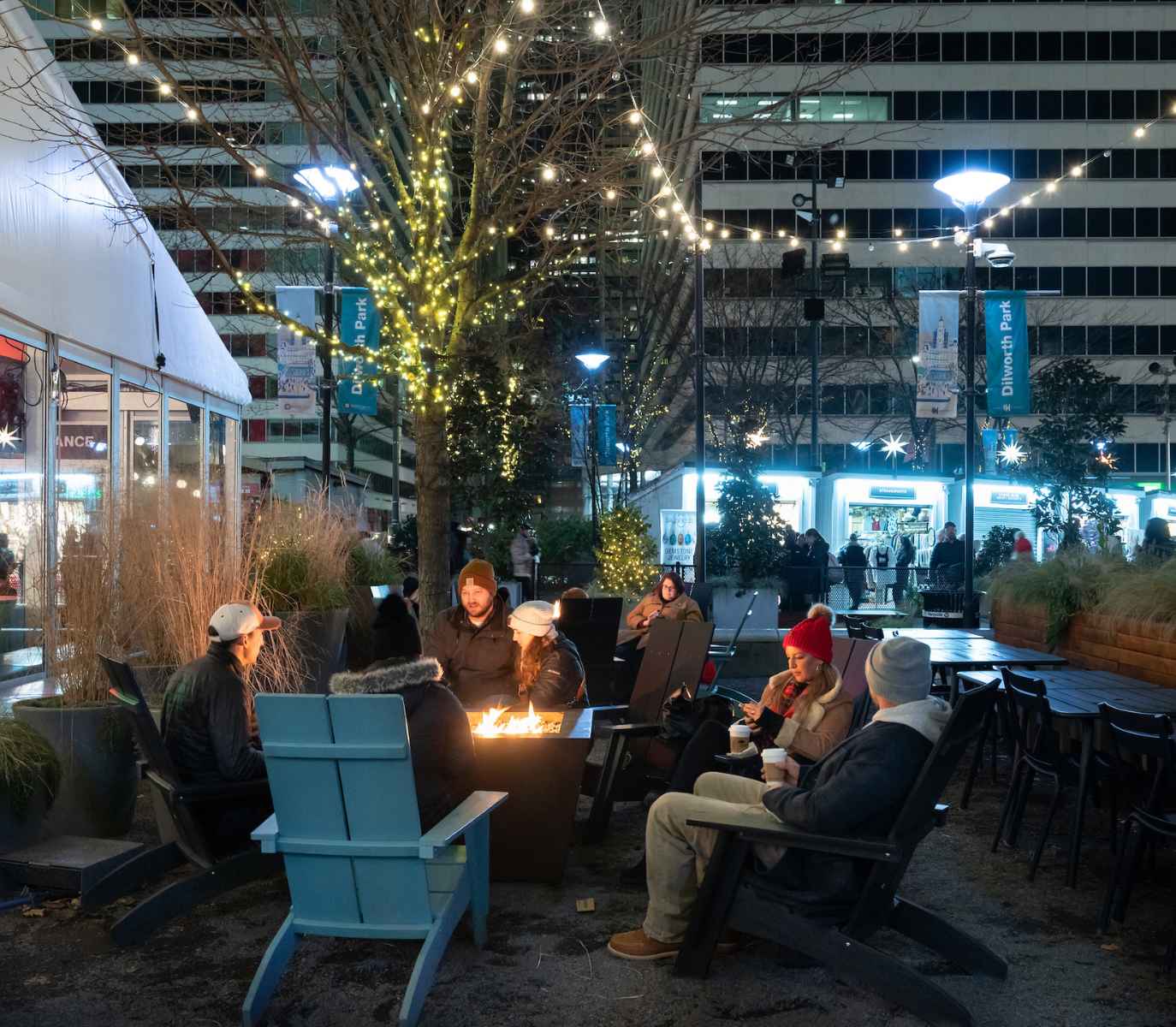 group of people sitting around a fire pit